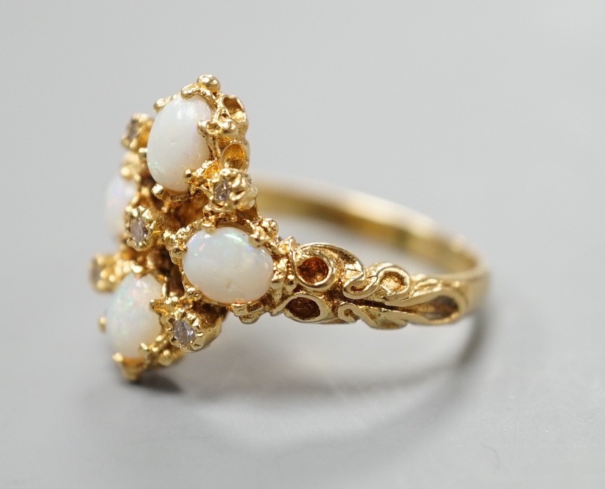 A 1970's 18ct gold, white opal and diamond chip set quatrefoil shaped ring, size O, gross weight 6.1 grams.